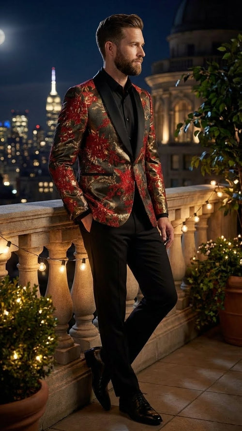 Red and gold paisley shawl lapel jacket for men. Fitted design with gold floral pattern on a red base. Features a shawl lapel and a slight sheen suggesting silk/polyester blend. Paired with black shirt & trousers.
