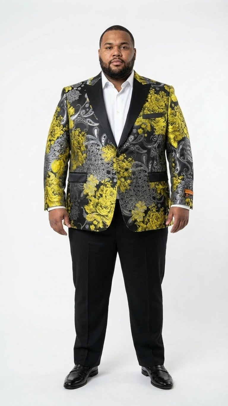 Yellow tuxedo blazer for men with black lapels & gold floral pattern. Structured fit, long sleeves, and black cuffs. Paired with black dress pants. Glossy sheen.