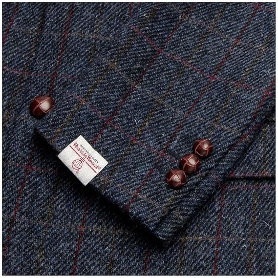 Dark blue Walker and Hawkes blazer in Harris Tweed. Subtle check with red/yellow lines. Features three brown cuff buttons and a label.