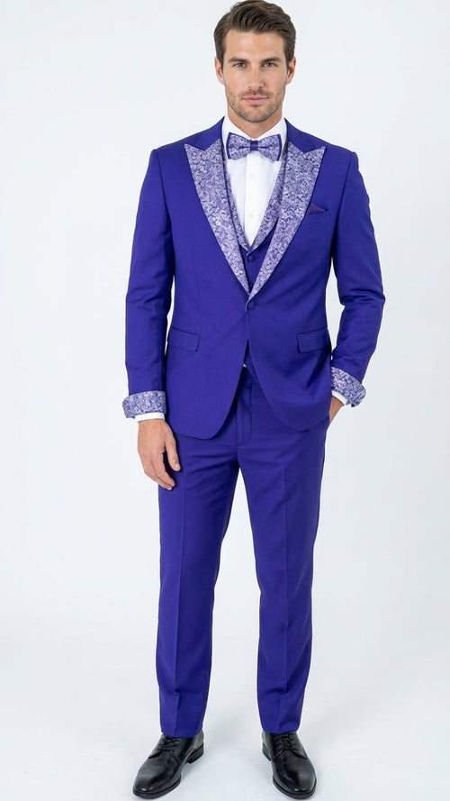 Men's purple tuxedo suit with tailored fit, silver lapel, and white shirt. Cuffs and bow tie boast a matching decorative pattern.