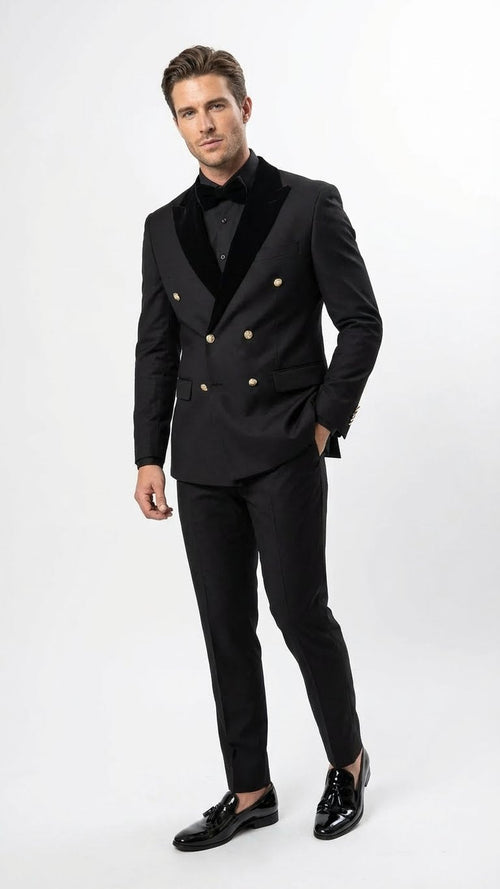 Men's black double-breasted tuxedo suit. Structured blazer with peaked lapels, gold buttons. Slim-fit trousers. Smooth, slightly sheened fabric. Classic formal wear.