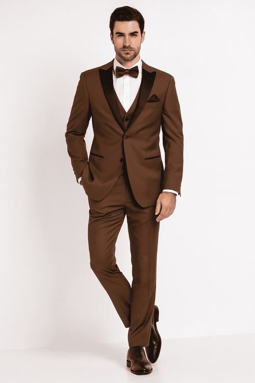 Men's light brown tuxedo suit with black satin lapel. Three-piece: jacket, vest, trousers. Smooth fabric, tailored fit, single-button jacket, pocket square, and matching bow tie.