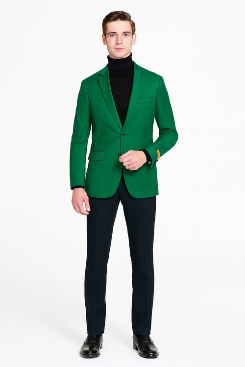Men's green blazer: tailored fit, single-button, notched lapels, chest pocket. Smooth fabric, structured shoulders, long sleeves with contrasting cuffs. Paired with slim-fit trousers.