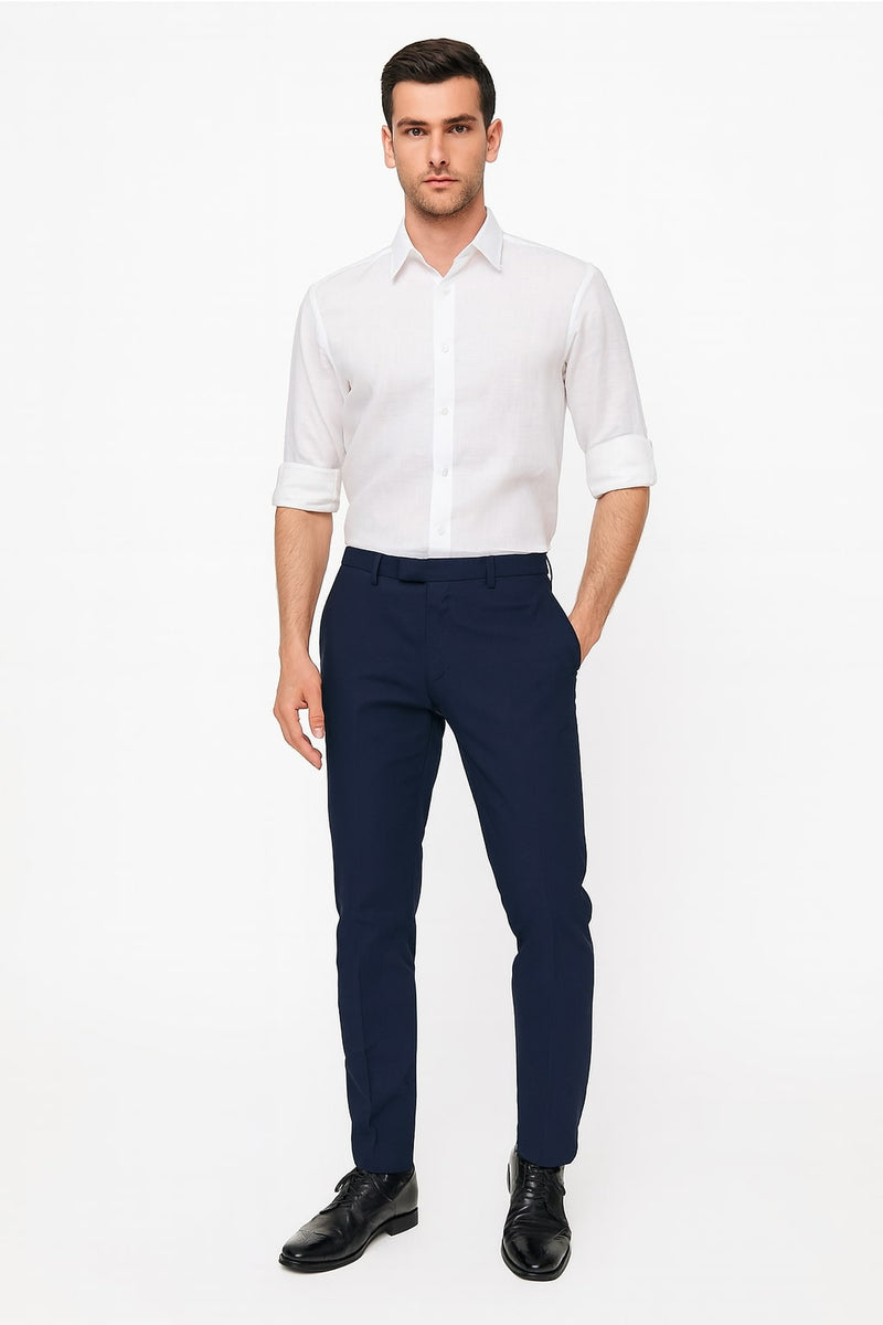 Men's white linen button-down shirt. Long sleeves rolled up, collared neckline, and button front. Lightweight, plain white linen fabric.