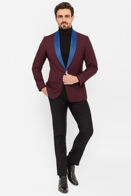 Burgundy men's tuxedo blazer with blue satin peak lapels. Single-button closure, fitted shape, and buttoned cuffs. Features a left chest pocket. Ideal for formal events.