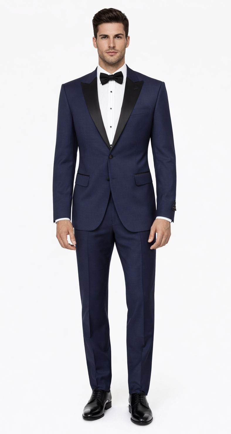 Navy blue tuxedo with peak lapel. Smooth fabric, button closure, and two front pockets. Sharp lines create a fitted look inspired by The Great Gatsby era.