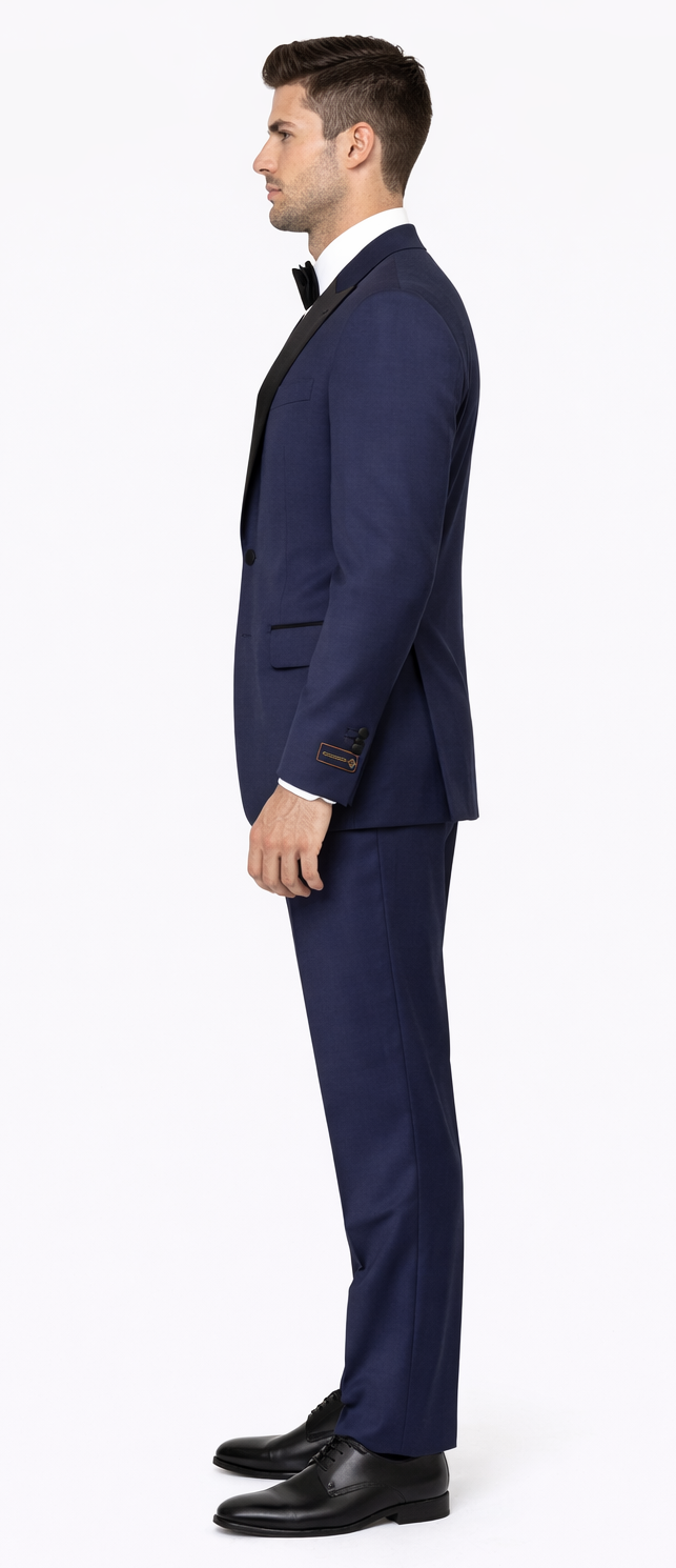 Navy blue peak lapel tuxedo inspired by The Great Gatsby. Sleek fabric, fitted silhouette. Two-button closure, side pockets. Paired with matching trousers and black shoes.
