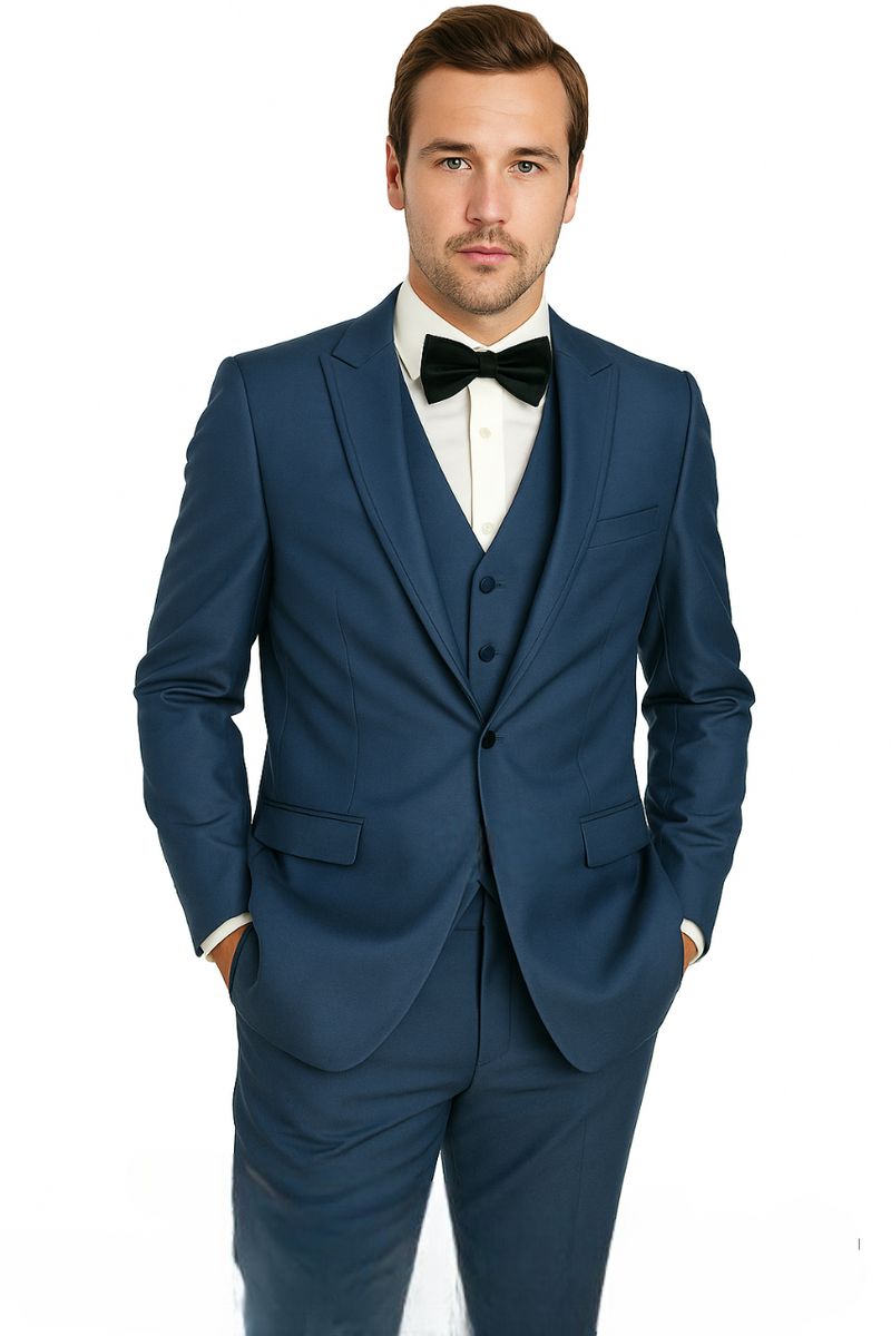Medium blue slim-fit tuxedo. Single-breasted jacket with peak lapel, two pockets, and included vest. Paired with matching trousers. Includes a white dress shirt and black bow tie for a complete formal look.