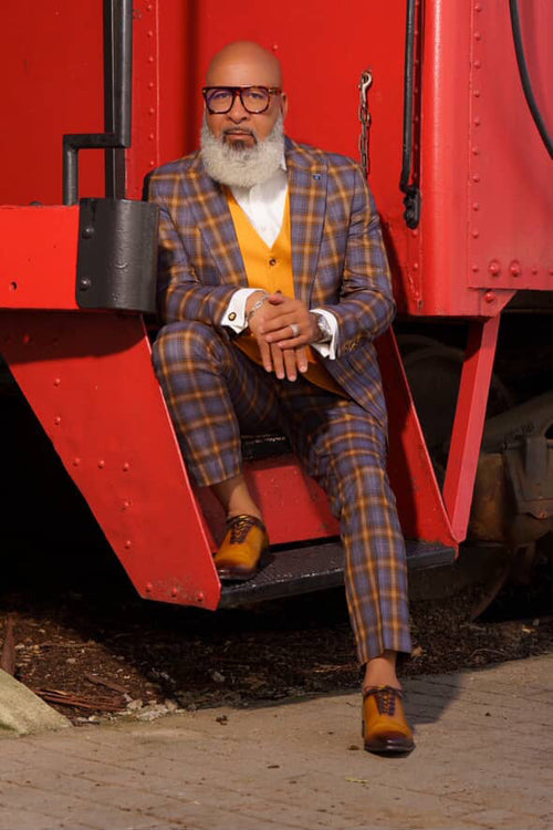 Grey & gold windowpane plaid Stacy Adams suit with vest. Classic fit blazer & trousers, paired with a solid gold vest and white dress shirt. Brown dress shoes complete the look.
