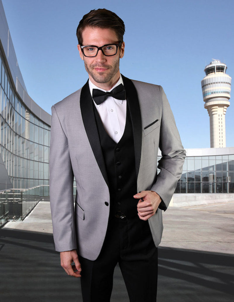 Grey wool-blend men's tuxedo with shawl lapel. Tailored single-breasted design, black lapel, three-button closure. Includes black vest and white dress shirt for a formal look.