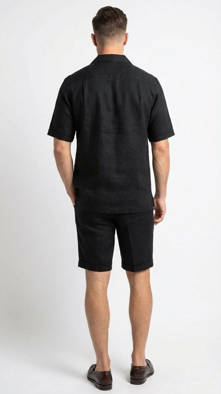 Men's black walking suit featuring a short-sleeved shirt and matching shorts. The shirt has a relaxed fit with a classic collar, and the shorts are tailored with a rolled cuff. Both pieces are made of a lightweight, textured fabric that appears breathable.