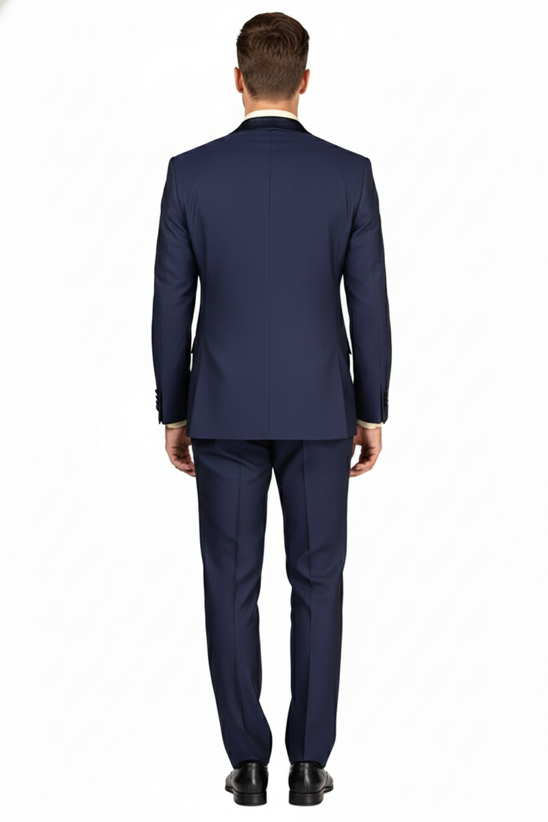 Navy blue double-breasted tuxedo for men. Features satin peak lapel, structured fit, visible stitching, and smooth fabric. Deep navy color with a subtle texture. Tapered trousers.