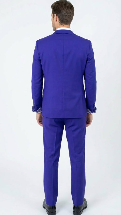 Men's purple tuxedo suit with white accents. Tailored, structured fit. Jacket with silver detailing on traditional lapels. Fitted pants. Formal style.