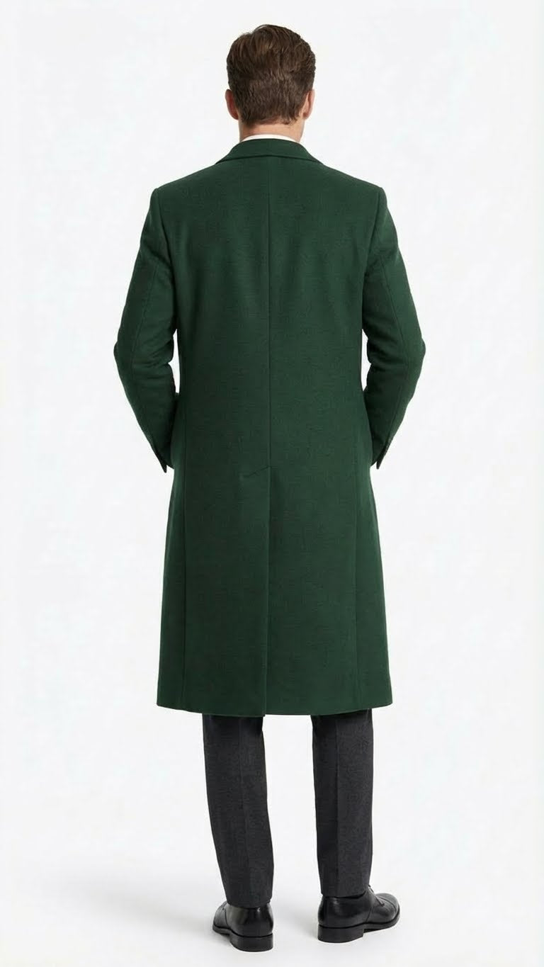 Hunter green men's overcoat. Full-length, tailored fit with straight silhouette. Features notch collar and single back vent. Textured wool fabric. Worn with gray trousers and black shoes.