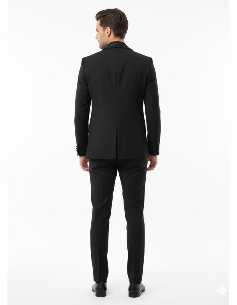 Classic black men's blazer with beaded lapel and tailored fit. Smooth fabric creates a sleek silhouette, visible from the back. Designer quality.