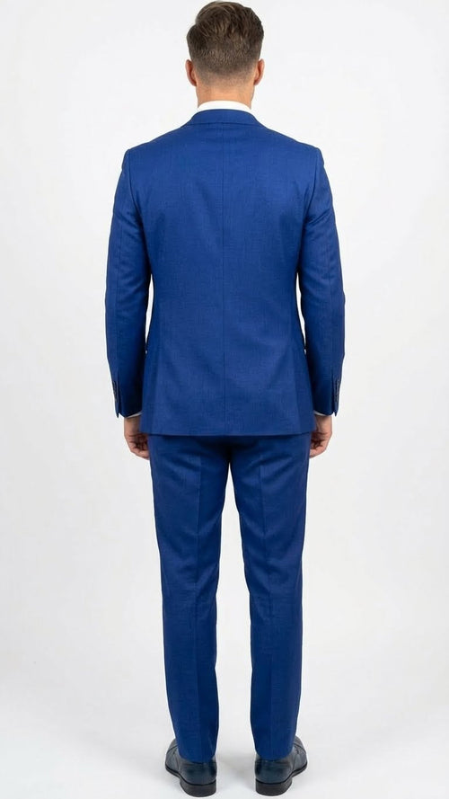 Men's royal blue 3-piece suit set with vest. Tailored fit, structured shoulders, single back vent. Solid royal blue color with subtle texture. Matching pants, uniform color scheme throughout.