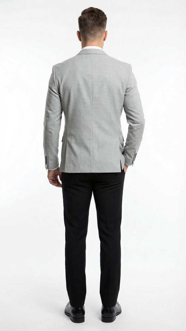 Men's light grey slim-fit blazer with a structured form, single back vent. Paired with straight-leg, solid black pants. Smooth blazer fabric with subtle texture.