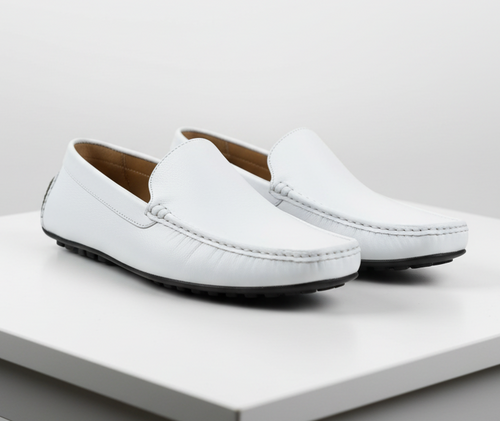 Men's white leather slip-on loafers. Classic design with smooth upper, stitching details, rounded toe, and black rubber outsole. Tan interior lining.