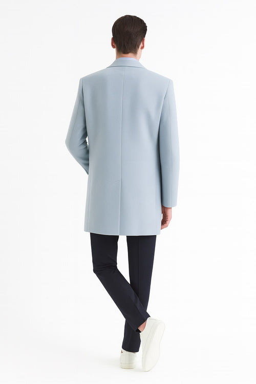 Men's light blue wool overcoat. Modern long silhouette, classic tailored fit. Sky blue color, structured shoulders, single back vent. Clean, refined lines.