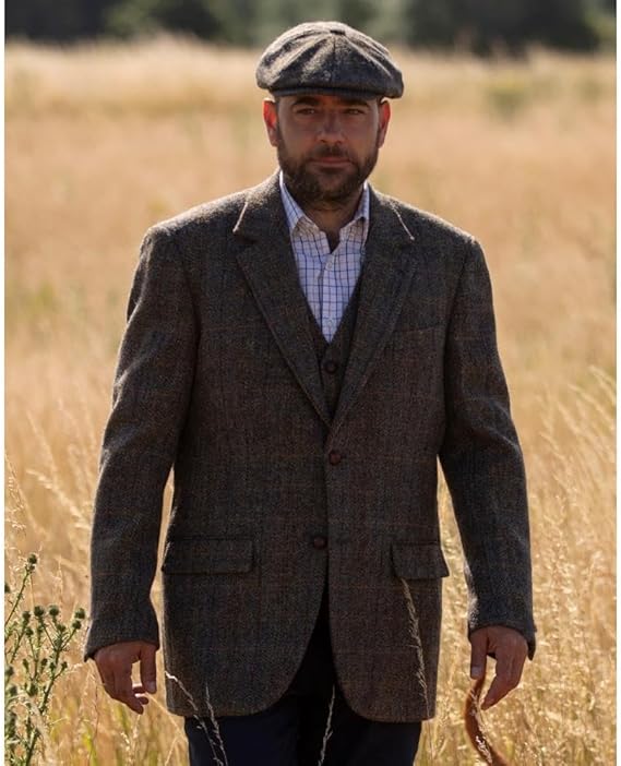 Men's Walker & Hawkes Blakemore blazer in textured brown Harris Tweed. Features a notched lapel, flap pockets, three-button closure, and a fitted shape. Fully lined for a smart, structured look.