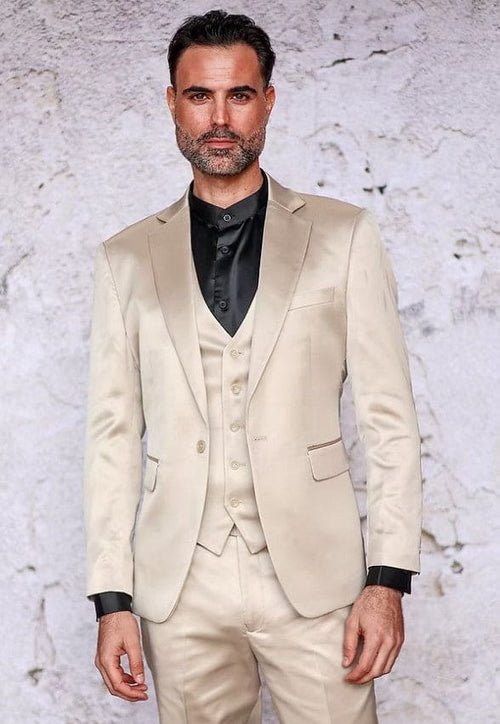 Men's champagne slim-fit suit in shiny satin. Three-piece set: jacket (single-button, notched lapel), vest, and trousers. Jacket has side pockets. Worn with a contrasting black shirt.