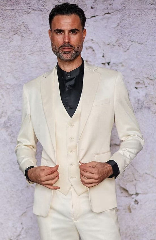 Men's slim-fit cream satin three-piece suit. Includes blazer (single-button), vest (multiple buttons), & trousers. Features a smooth, reflective texture and reveals a black shirt.