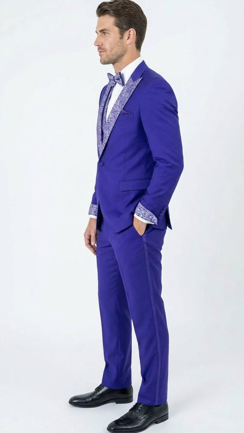 Alberto Nardoni men's tuxedo. Fitted, purple suit with white/silver lapel & cuff embellishments. Single-breasted jacket, tapered pants create a streamlined silhouette. Notch lapel, left pocket.
