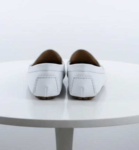 White leather men's loafers: classic slip-on design with rounded toe & glossy finish. Squared heel with stitching detail & flexible sole. Simple & elegant.