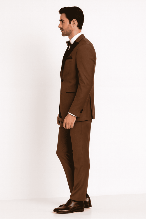Light brown men's three-piece tuxedo with black satin lapel. Tailored jacket, straight-leg trousers. Includes a white dress shirt. Uniform color, sleek, and pattern-free design.