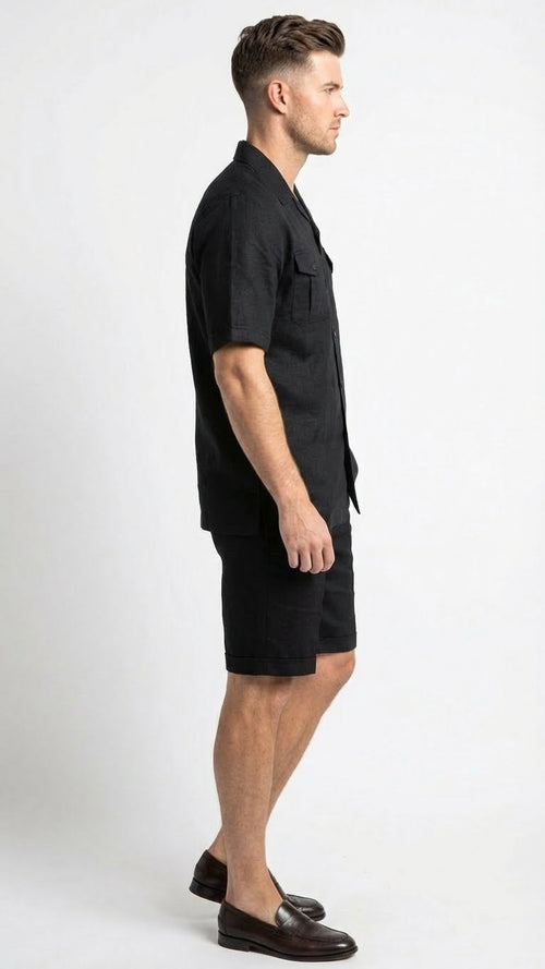 Men's black walking suit features a short-sleeved button-up shirt and matching black shorts. The shirt is loose-fitting with a straight cut and a collar, while the shorts are knee-length with a simple design. Both pieces appear to be made of a lightweight fabric, suitable for comfortable wear.