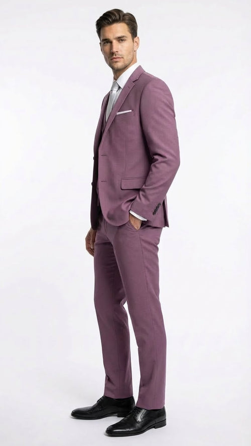 Mauve three-piece men's suit: slim fit blazer (structured shoulders, single-breasted), vest (V-neck), and trousers (straight legs). All in a consistent mauve, textured fabric. Formal.