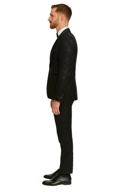 Black sequin tuxedo suit with satin shawl lapel. Fitted jacket and matching trousers, both covered in shimmering black sequins. Perfect for a glamorous look.