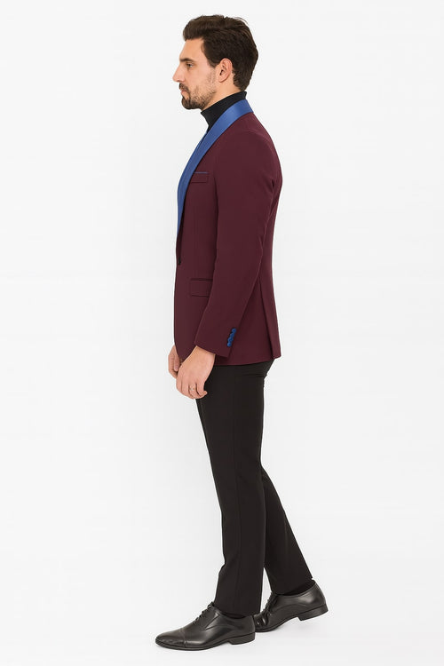 Men's burgundy tuxedo jacket with a fitted shape, blue satin shawl collar, and single-button front. Includes side pockets and three blue cuff buttons.