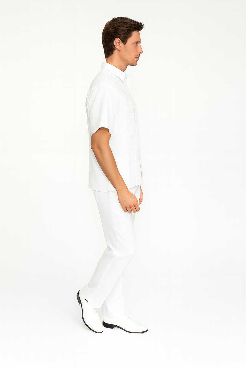 Men's white linen guayabera set: short-sleeve embroidered shirt & matching pants. Classic collar, relaxed fit shirt. Tailored pants for a streamlined look. Both pieces are solid white.