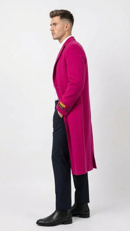 Hot pink men's wool blend overcoat with tailored, straight silhouette and structured shoulders. Features classic lapel, functional cuffs, and contrasting dark trousers. Simple, distinctive design.
