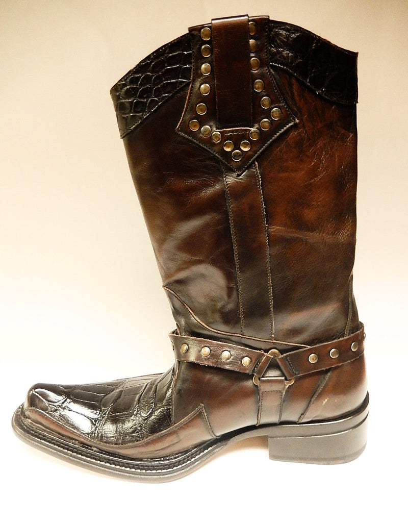 Mauri 44238: Tall, dark brown leather boots with alligator-like texture and pointed toe. Features metallic stud detailing, ankle strap, and a moderately raised heel.
