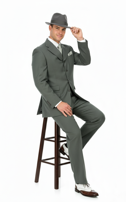 Classic 1920s gray zoot suit: tailored jacket with wide lapels, high-waisted baggy trousers, matching tie/pocket square, gray fedora, and two-tone shoes. Lightweight fabric.