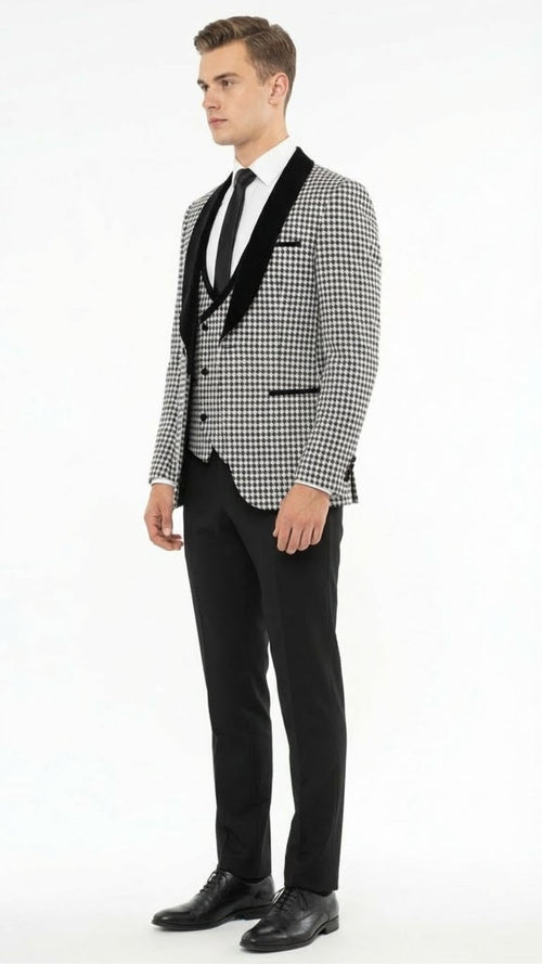 Men's houndstooth tuxedo set: black & white. Structured jacket with velvet shawl lapel & peaked collar. Fitted black trousers complete the formal look.