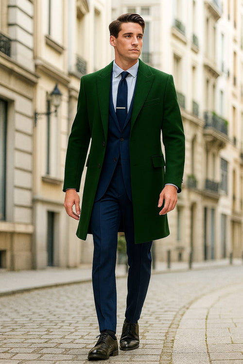 Dark green wool overcoat with long, straight silhouette. Notched lapel, two front pockets, and single-breasted closure. Tailored, structured design, suitable for formal and casual wear.