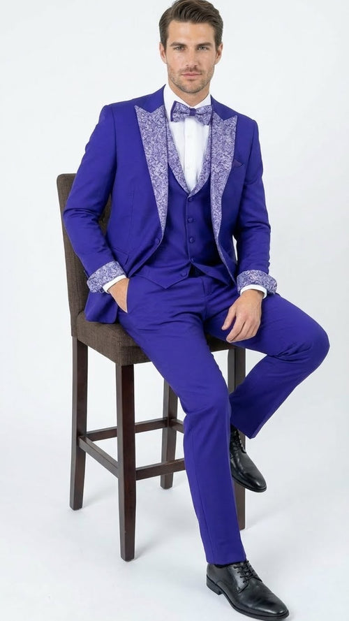 Alberto Nardoni men's tuxedo suit: Purple with white embellished lapels & cuffs. Single-breasted jacket, matching trousers, white shirt, and purple bow tie. Smooth materials with textured accents.