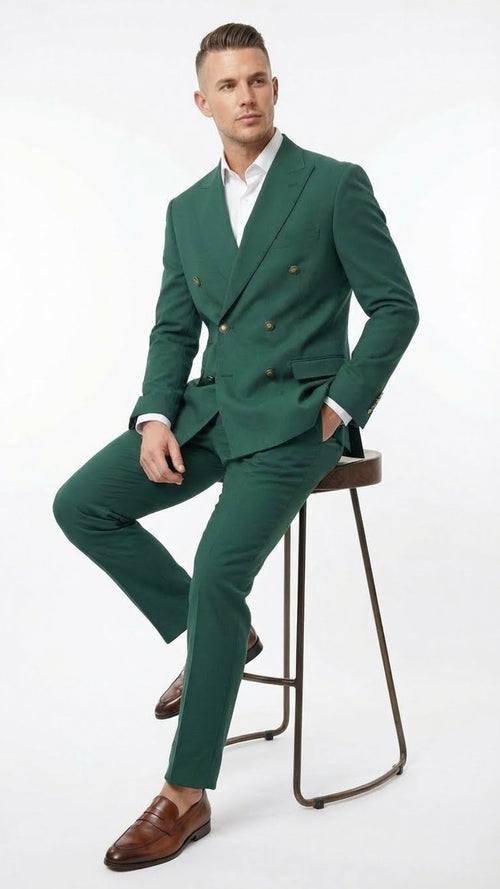 The vibrant emerald green double-breasted suit features two rows of brass buttons, structured lapels, and tailored trousers. It is made of a smooth fabric, presenting a fitted silhouette.