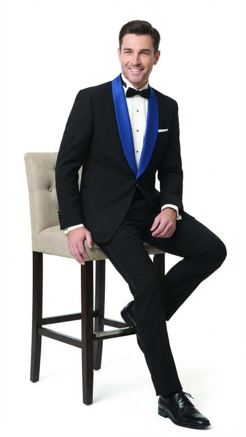 Men's black tuxedo with royal blue shawl lapel. Solid black fabric, smooth finish. Includes white dress shirt, black bow tie, tailored trousers, and black dress shoes.