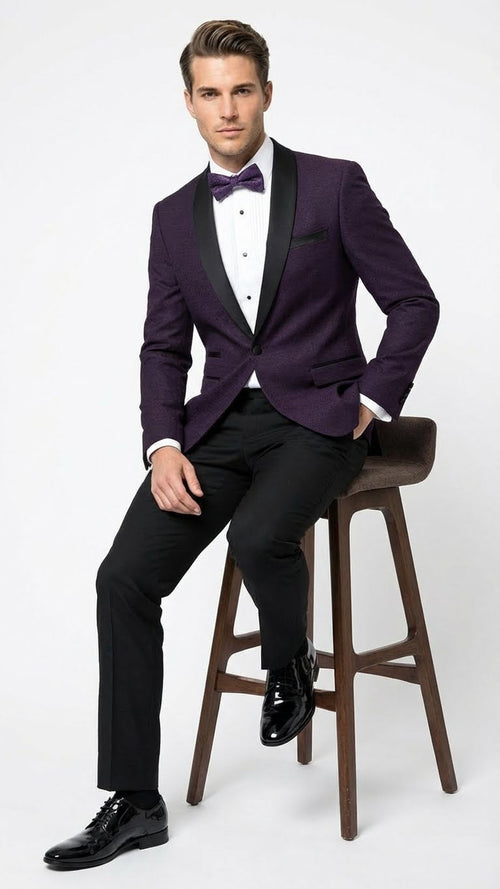 Eggplant purple men's tuxedo blazer with satin lapel. Structured silhouette, single-button closure, and two front pockets. Textured fabric.