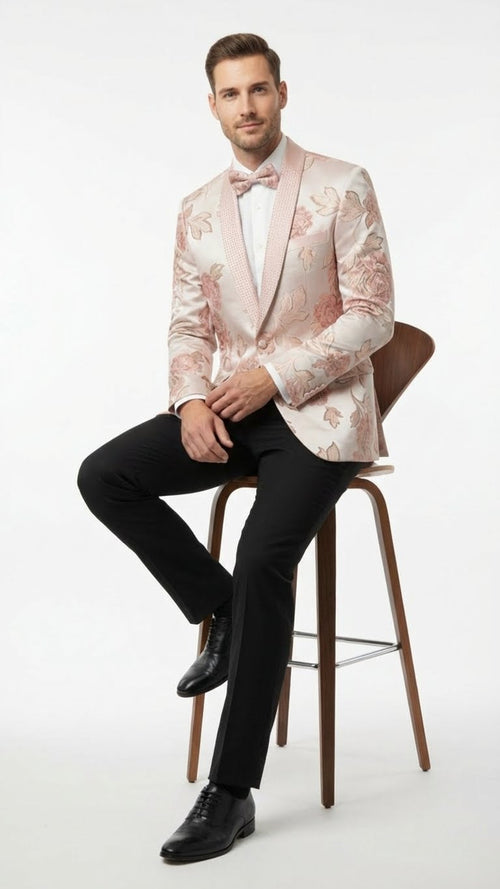 Pink blush floral jacquard blazer with structured silhouette, single-button closure, and embellished shawl lapel. Features varied pink floral patterns, textured finish, fitted sleeves, and contrasting white cuffs. Tailored elegant fit.