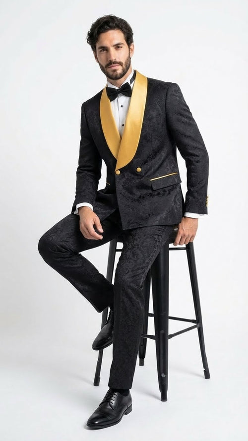 Men's black jacquard tuxedo suit with a slim fit. Gold shawl collar, button & pocket trim accents. Includes matching trousers. Complete with black dress shoes.