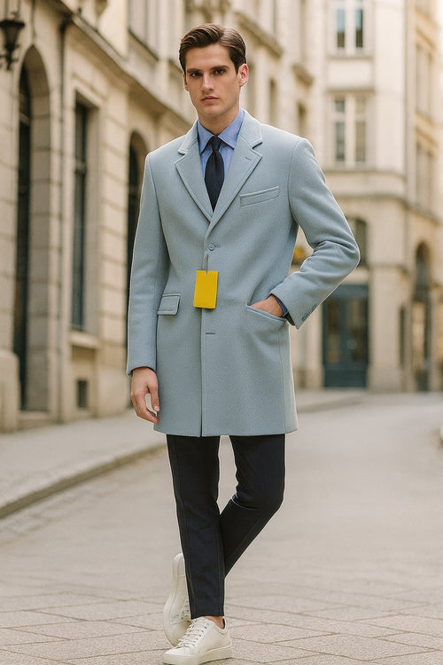 Light blue wool overcoat. Classic tailored fit with a modern long design. Single-breasted, notch lapels, chest & side pockets. Smooth texture, highlighting the wool.
