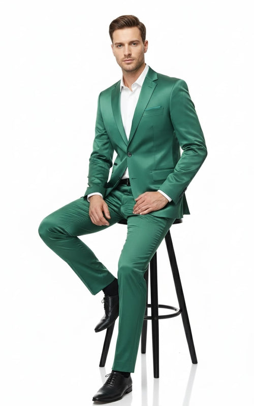 Emerald green sateen two-piece slim fit suit. Features single-button blazer with notched lapels & chest pocket, plus straight-leg pants. Smooth, reflective satin fabric.