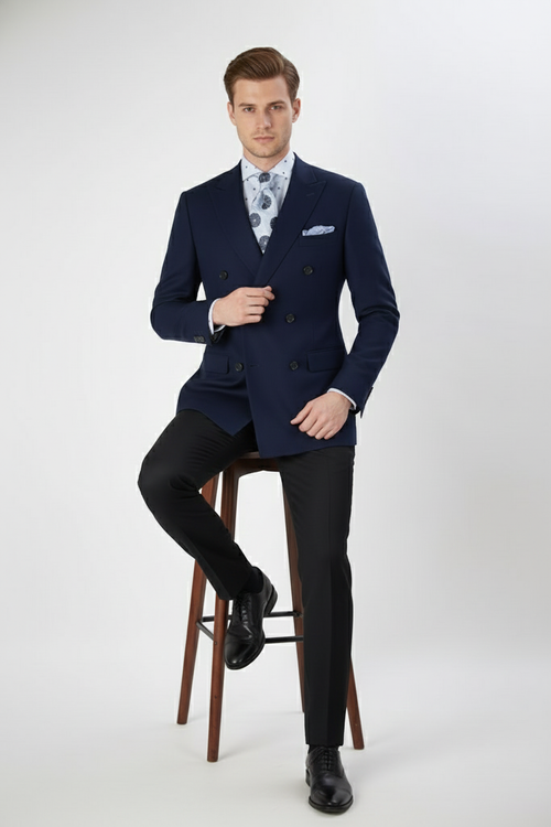 Alberto Nardoni navy double-breasted blazer. Structured, tailored fit with peak lapels, buttoned cuffs, and pocket square. Solid navy fabric, smooth finish.