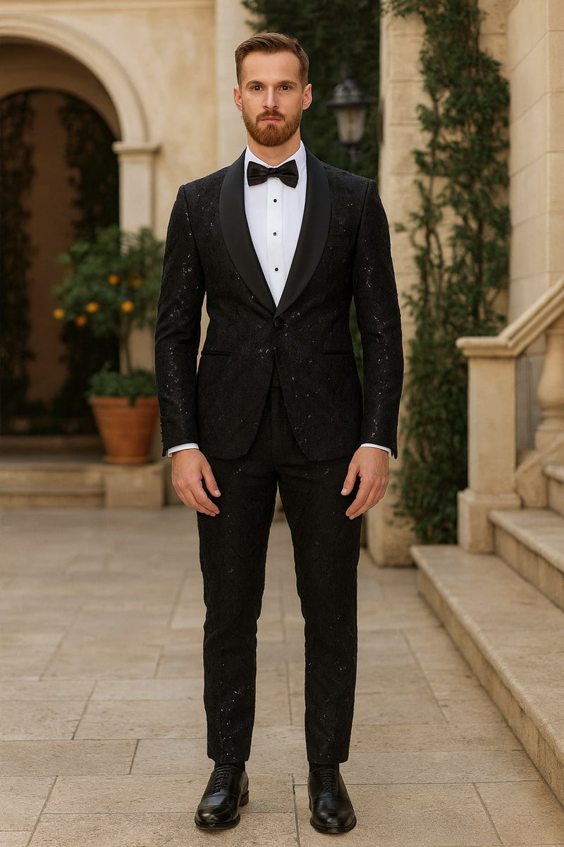 Black sequin tuxedo suit with satin shawl lapel. Fitted jacket with single button closure, matching tailored trousers. Textured sequin pattern, smooth satin lapel contrast. Uniform black color, sleek design. Includes black shoes.