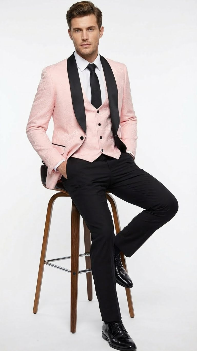 Men's blush pink tuxedo suit set with black shawl lapel. Fitted jacket, subtle pattern, one-button closure. Black straight-leg trousers. Includes light shirt and black tie.